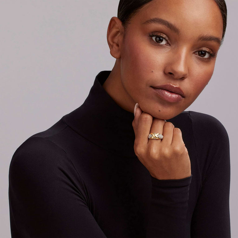 A woman wearing a Sterling Silver & 18K Gold ring featuring an x motif and caviar beading