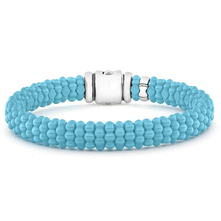 A sterling silver beaded bracelet in the middle of a white background featuring light blue ceramic caviar beading and a sterling silver box clasp.