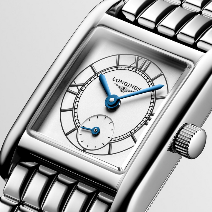 This is a close-up of a Longies watch angled to the right, showcasing the dial with a white background. The rectangular-shaped watch features a white dial, blue hands, black markers, a stainless steel bezel, and a stainless steel bracelet.