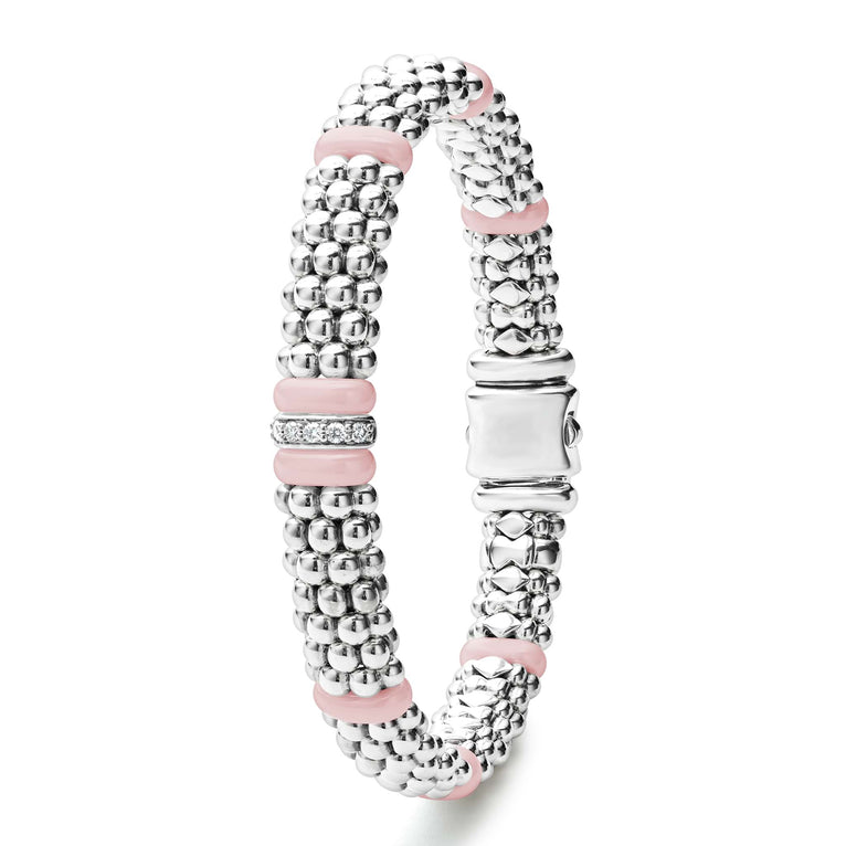 A sterling silver & 18k gold bracelet stands vertically in the middle of a white background, featuring pink ceramic and Caviar beading.