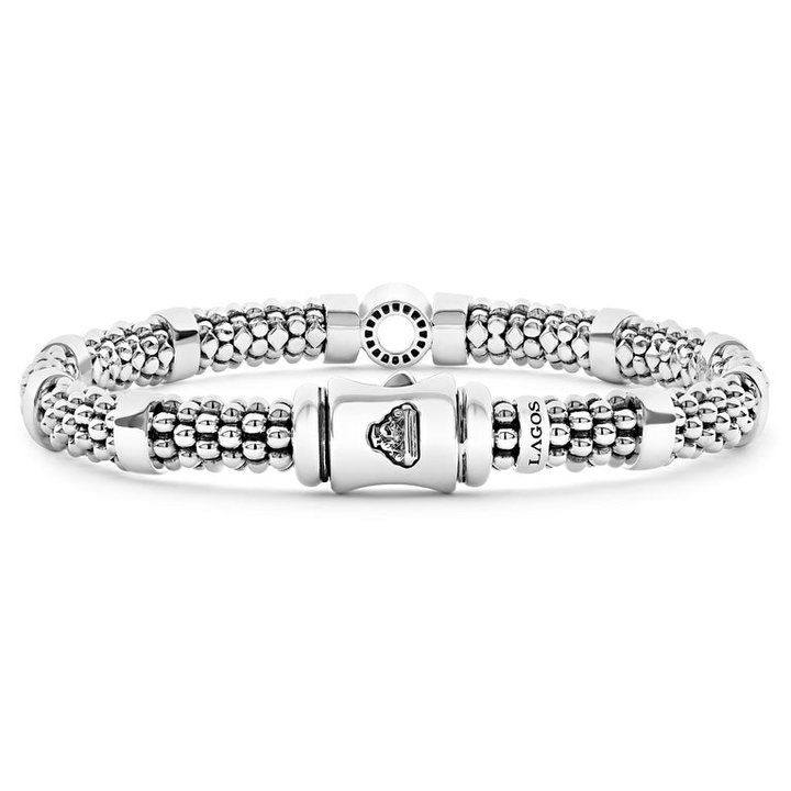 A sterling silver bracelet in the middle of a white background featuring one diamond circle station and caviar beading.