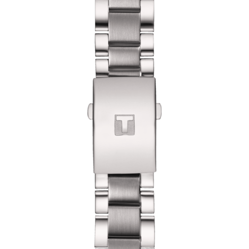 A close-up of a Tissot watch with a stainless steel bracelet and engraved clasp. 