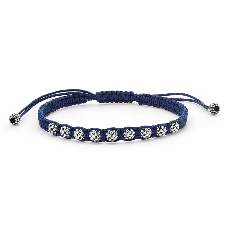 A navy blue bracelet is displayed in the middle of a white background, featuring braided nylon with sterling silver Caviar beads.