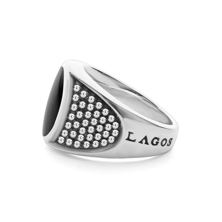 A side-view of a sterling silver ring in the middle of a white background featuring a black agate gemstone and sterling silver Caviar beading