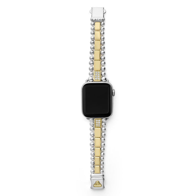 An Apple watch rests in the middle, showcasing the LAGOS engraved clasp against a white background. The watch band features 18K gold-stationed links and stainless steel beading around the links.