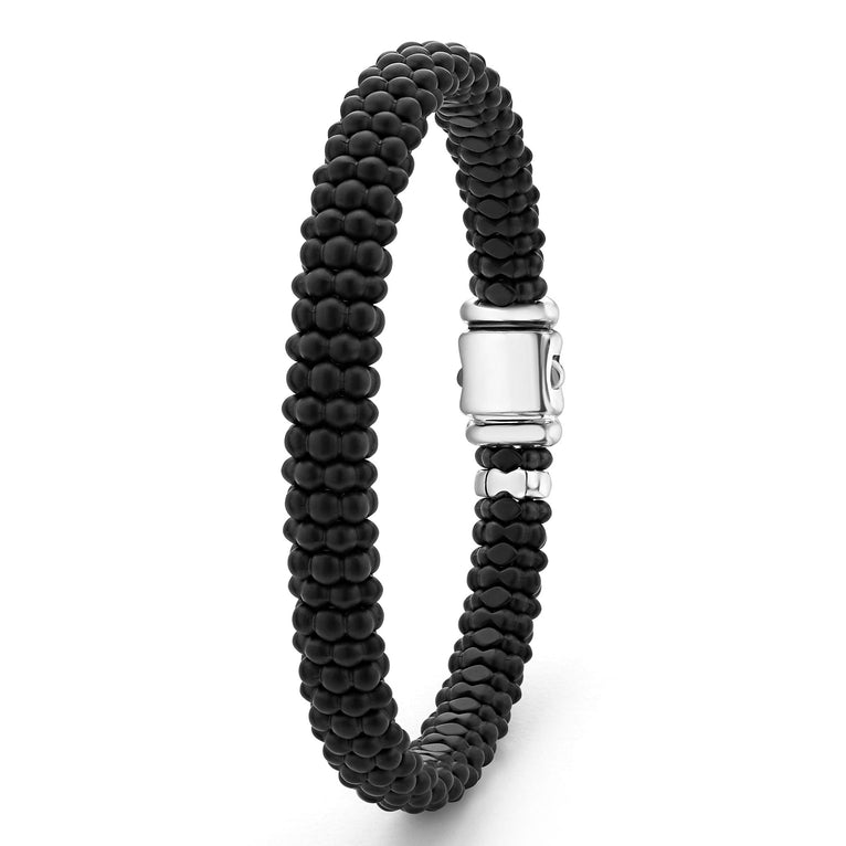 A sterling silver beaded bracelet standing vertically in the middle of a white background, featuring Matte black ceramic caviar beading