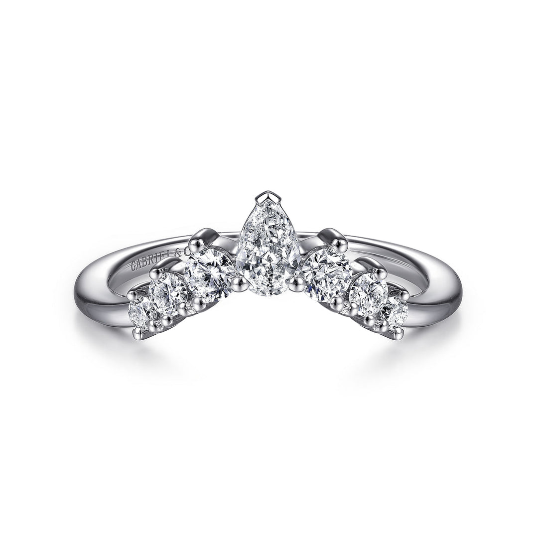 A white gold ring lies flat against a white background. The tiara-curved band features five princess-cut diamonds with a shared prong. 