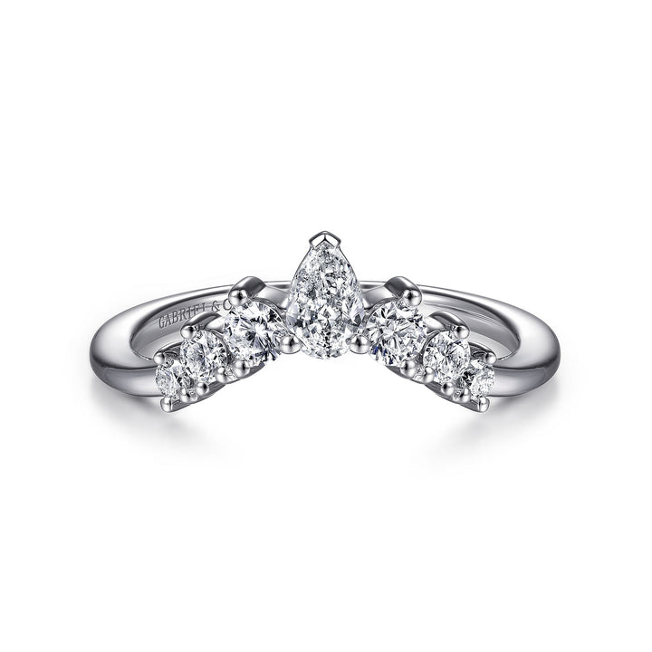 A white gold ring lies flat against a white background. The tiara-curved band features five princess-cut diamonds with a shared prong. 