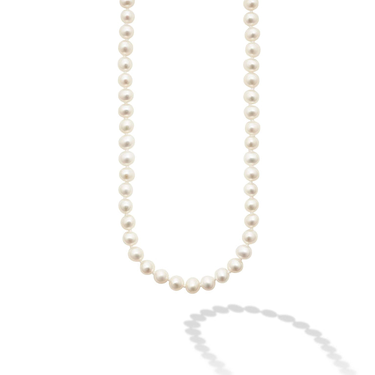 This is a close-up of a sterling silver &18k gold necklace featuring a strand of cultured freshwater pearls accented by sterling silver and 18K gold finished on a signature lobster clasp