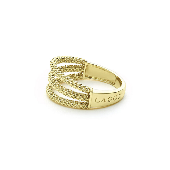 A side-view of An 18K Gold ring in the middle of a white background featuring three rows with caviar beading.