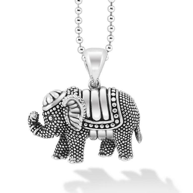 A sterling silver necklace in the middle of the white background focusing on a elephant pendant