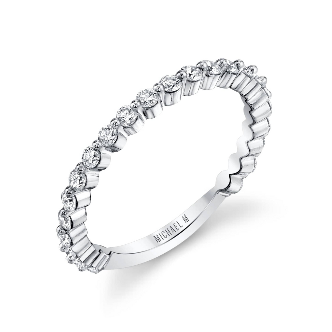 This is a close-up of the side view of the white gold ring. It features a bezel set of round diamonds and a white gold band.