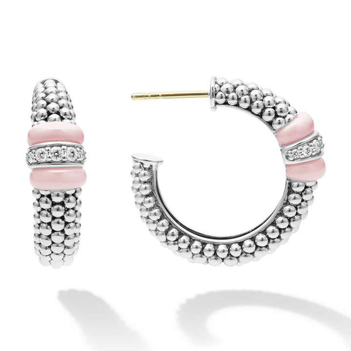 A pair of hoop earrings with pink ceramic and a diamond station with sterling silver Caviar beads. The right earring is angled to the side.