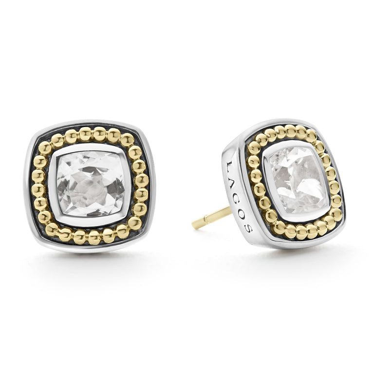 A pair of stud earrings with a White topaz gemstone surrounded by sterling silver and 18k gold Caviar beading. The right earring is angled to the side.