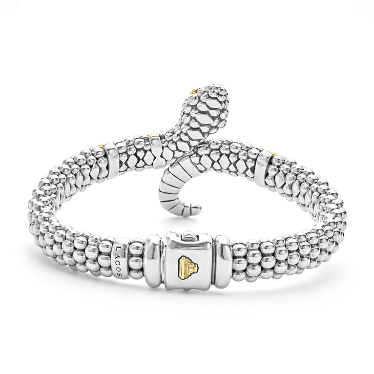 A back-view of sterling silver & 18k gold bracelet in the middle of a white background featuring a snake motif, gold stations, and sterling silver caviar beading.