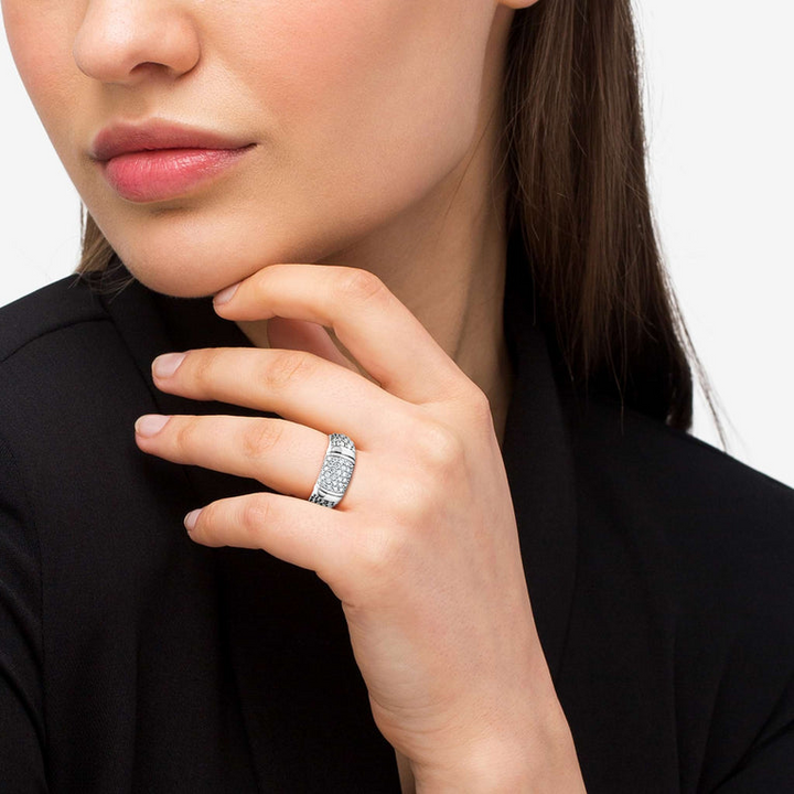 A woman wearing a Sterling Silver ring featuring smooth sterling silver stations, caviar beading, and diamond-set stations.