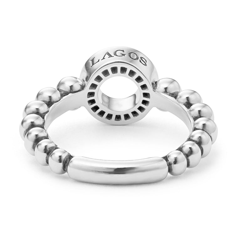 A back-view of a sterling silver ring is displayed on a white background featuring diamond circle detailing the LAGOS logo sits on a tapered Caviar beaded band