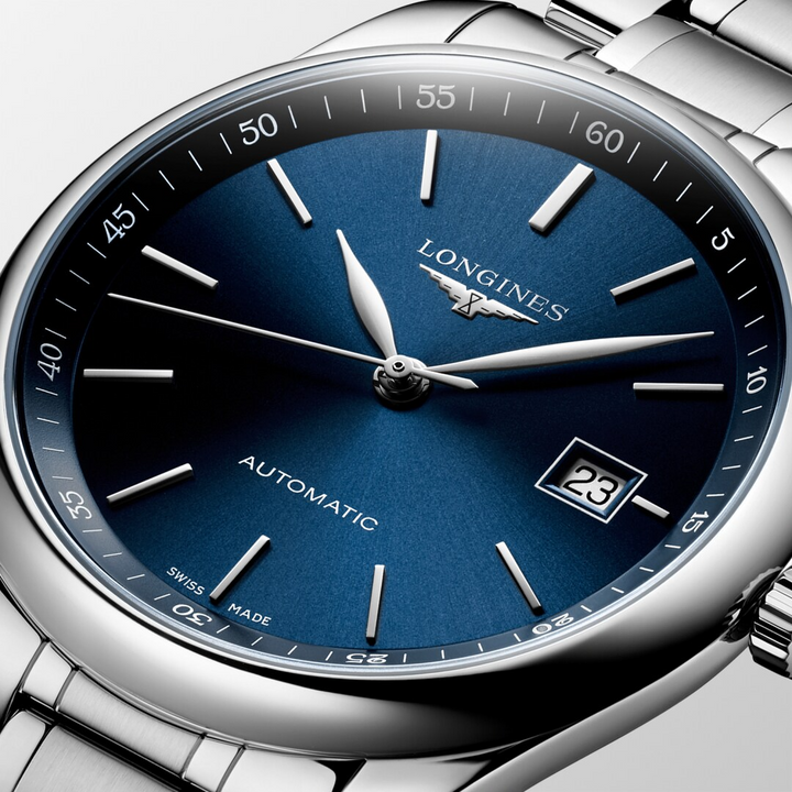 A close-up of a Longines watch highlighting the blue dial and crown. 