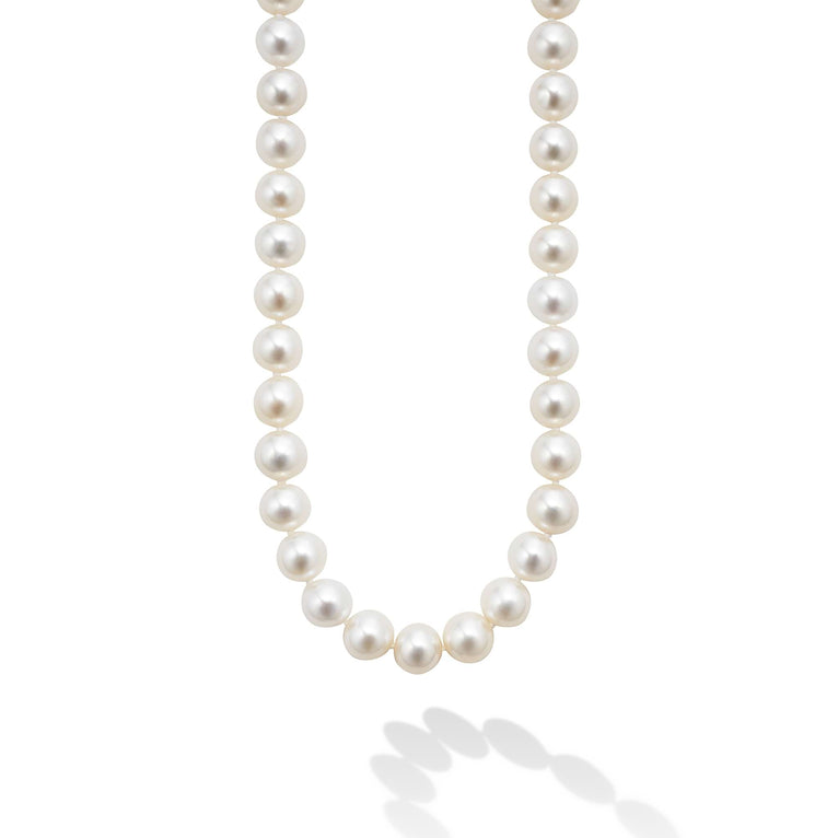 This is a close-up of a sterling silver &18k gold necklace featuring a strand of cultured freshwater pearls accented 