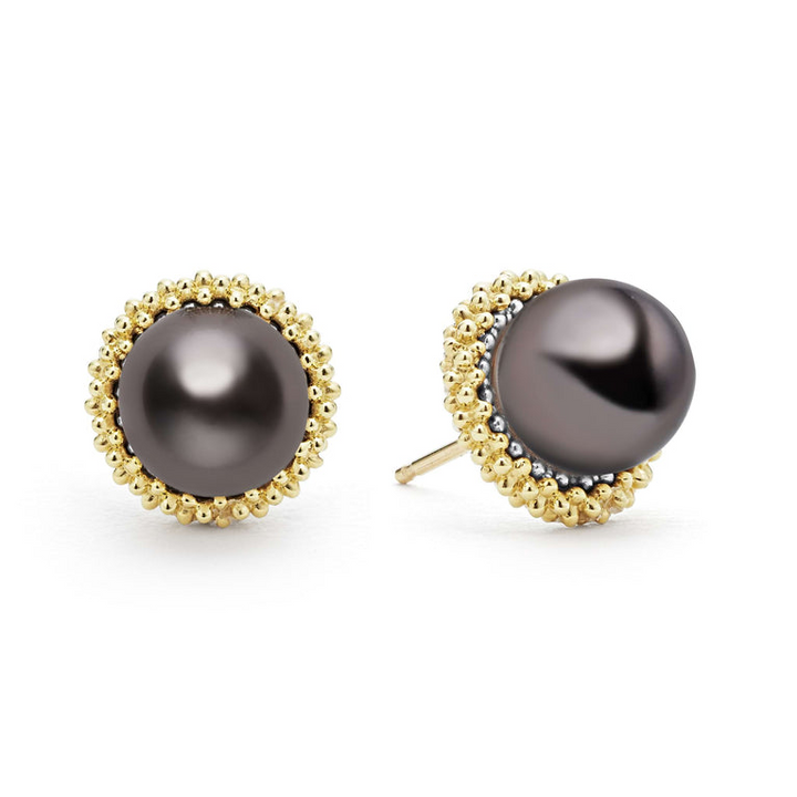 Tahitian black pearl stud earrings set in 18K gold Caviar beading. The right earring is angled.