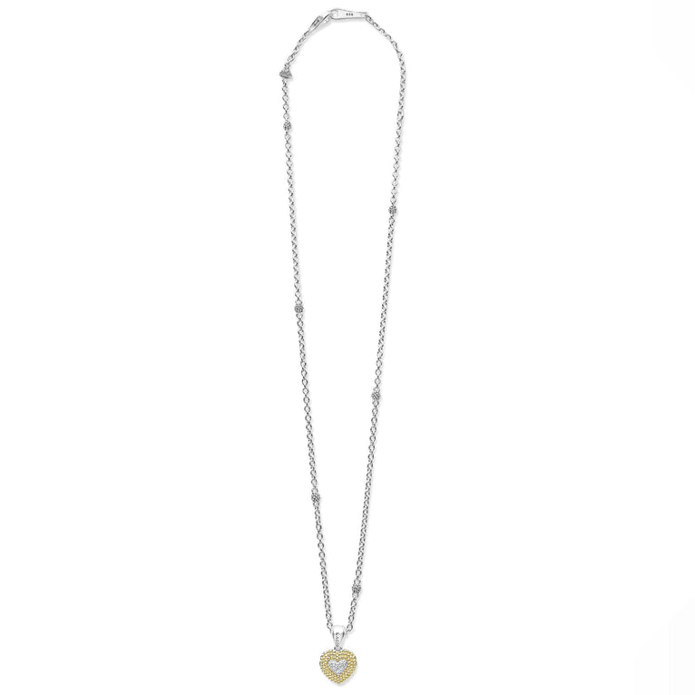 A sterling silver &18k gold necklace featuring a diamond heart pendant framed by 18K Gold Caviar beading and showing the clasp at the top against a white background.