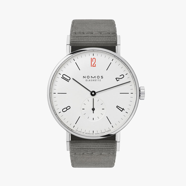 A Nomos Glashutte watch stands straight against a white background. It features a white dial, black hands and markers, a stainless steel bezel, and a gray strap.