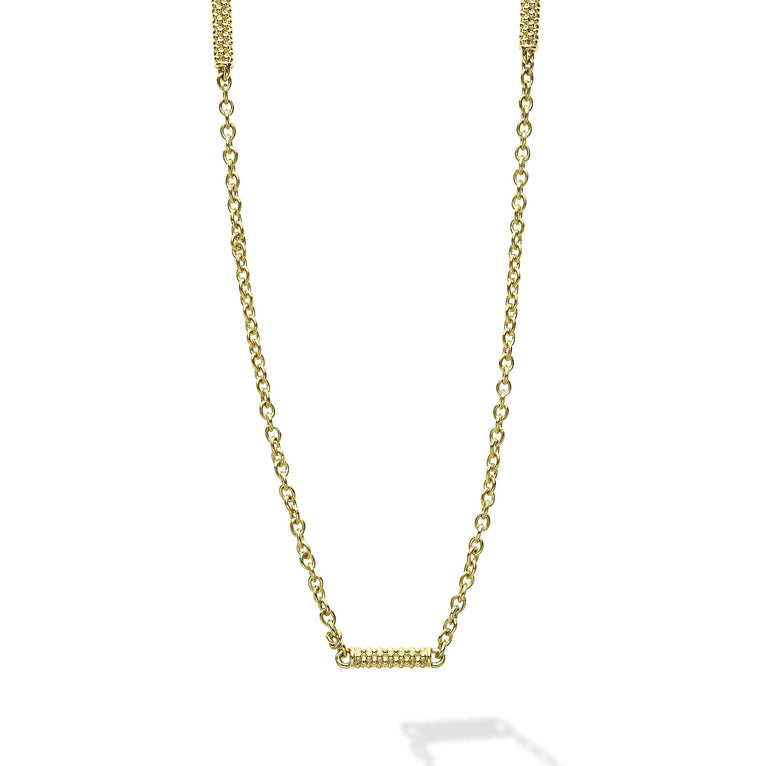 Close-up of an 18k gold chain necklace featuring caviar-beaded stations on a white background.