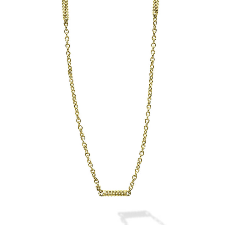 Close-up of an 18k gold chain necklace featuring caviar-beaded stations on a white background.