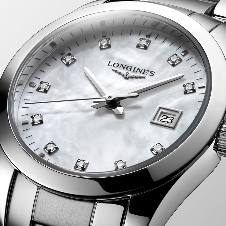 This is a close-up of a Longies watch angled to the right, showcasing the dial with a white background. The watch features a white mother-of-pearl diamond-set dial, silver hands and markers, a stainless steel bezel, and a stainless steel bracelet.