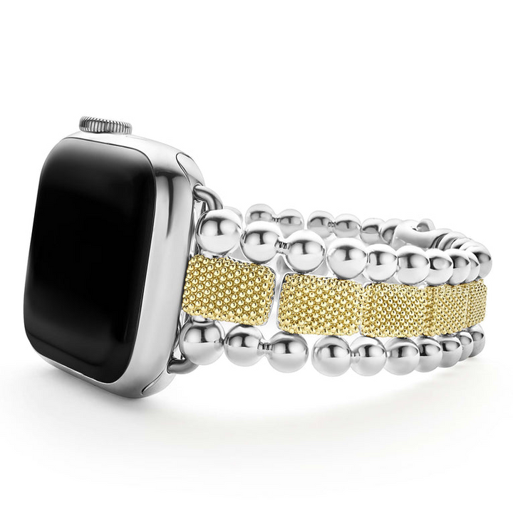 An Apple watch resting on its left side against a white background. The watch band features 18K gold-stationed links and stainless steel beading around the links.