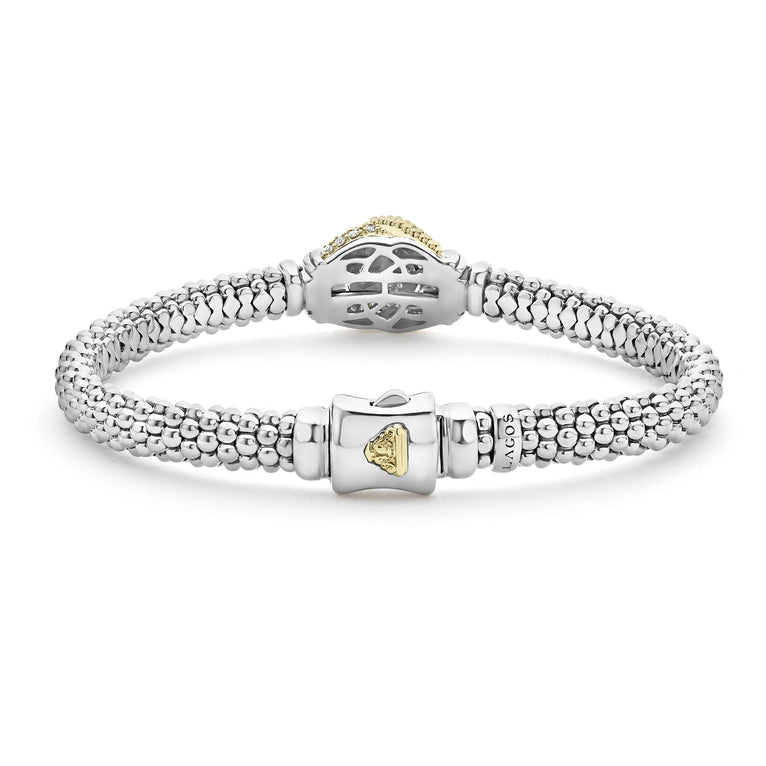 Showing the back of a Sterling Silver & 18k gold bracelet opened in the middle of a white background highlighting the clasp. The bracelet features diamonds and gold women in a knot motif.