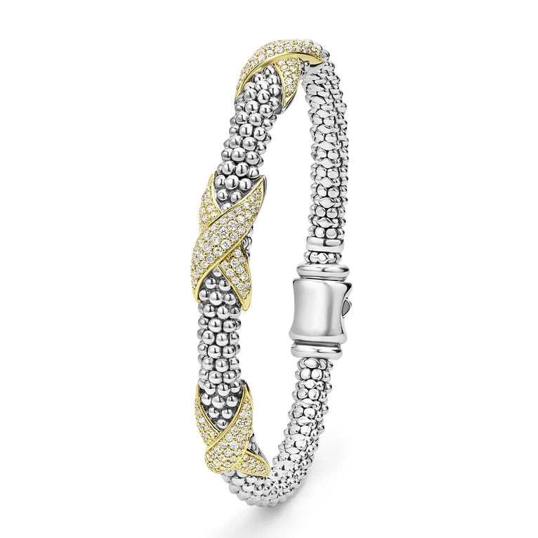 A Sterling Silver & 18k gold bracelet is angled to the side in the middle of a white background. The bracelet features diamond-set X stations, caviar beading, and a stainless steel clasp.