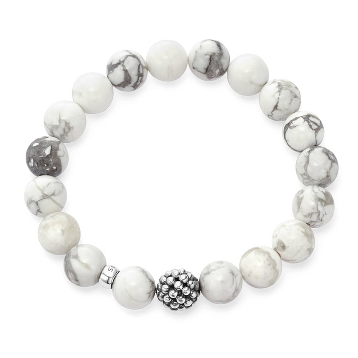 A bracelet is in the middle of a white background, featuring Howlite gemstone and silver Caviar bead station.