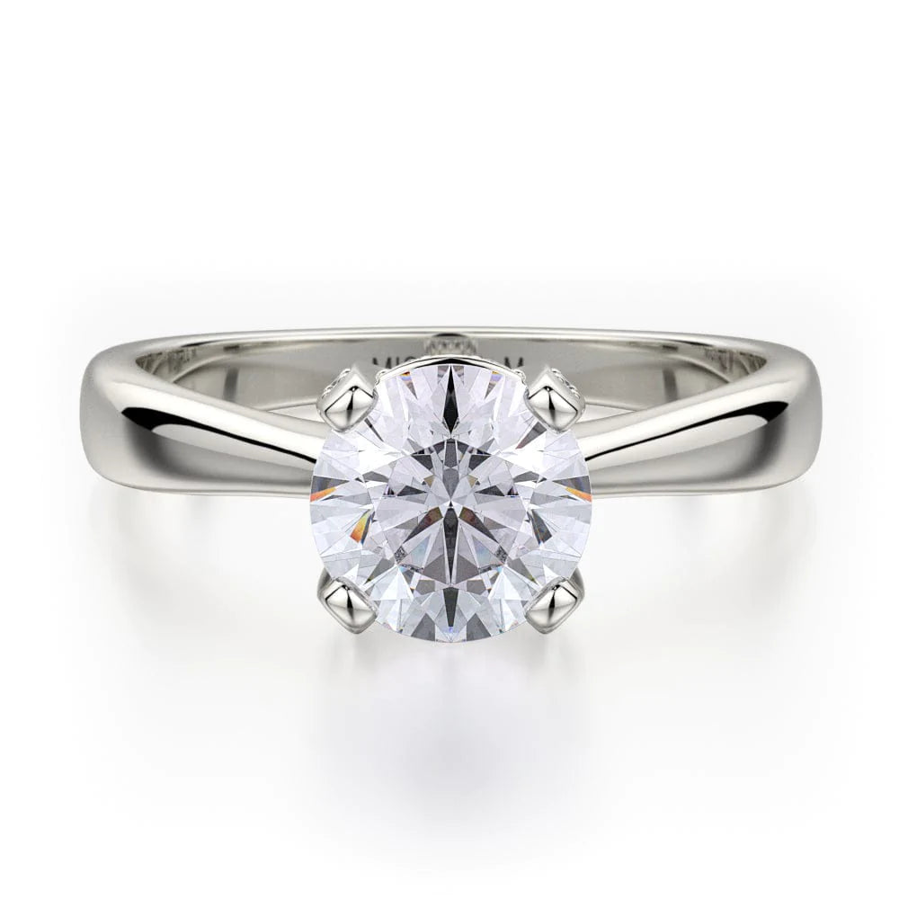 Front view of a Michael M. white gold engagement ring with a round center stone and polished solitaire band.