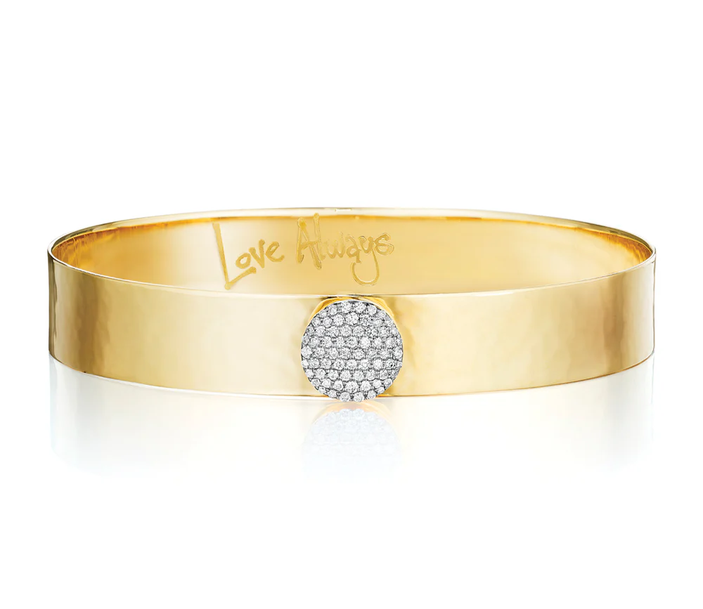 Close up of Phillips House 10mm Yellow Gold Love Always Bracelet, with Love Always engraved on the inside of the bracelet on a white background.