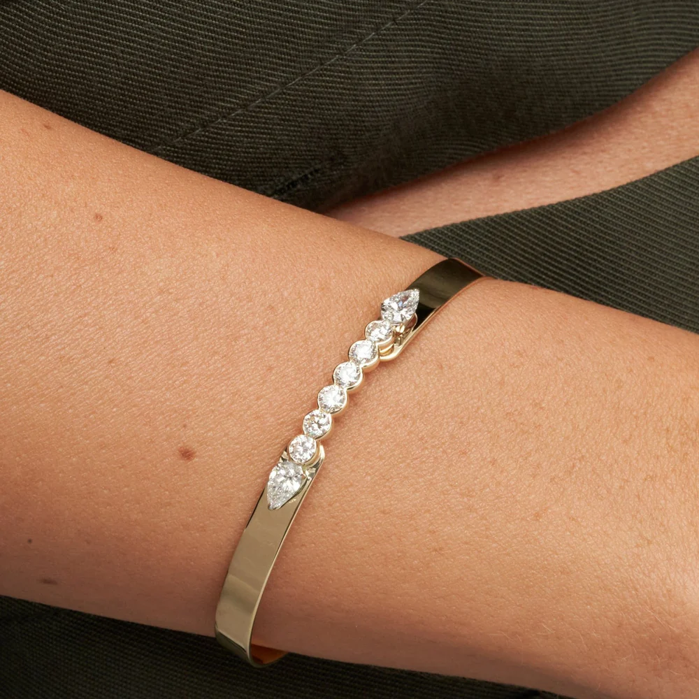 Close up of a woman's wrist wearing a Phillips House Yellow Gold Love Always Bracelet.