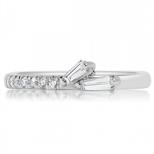 A white gold ring lies flat against a white background. It features a tapered baguette diamonds cluster on the shank and a round diamond-set band