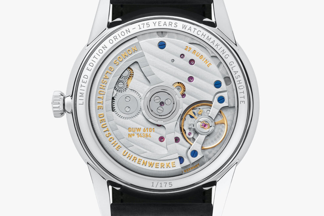 The back of a Nomos Glashutte watch showcases the back of the dial, stainless steel bezel, and strap.