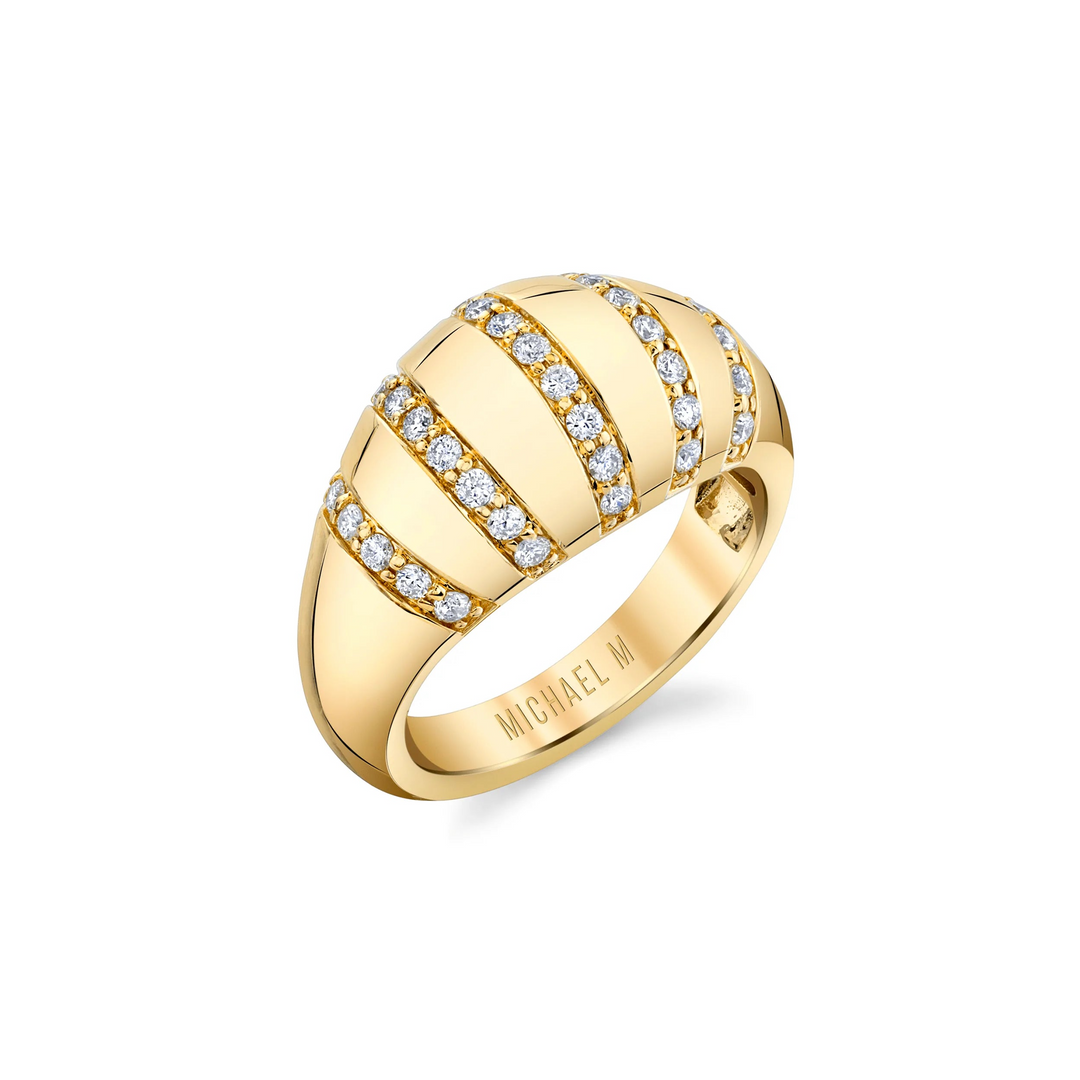 A yellow-gold ring lying flat against a white background. The ring features five rows of round paved set diamonds on a domed-shaped signet ring with the "Michael M" inscription visible inside the band.