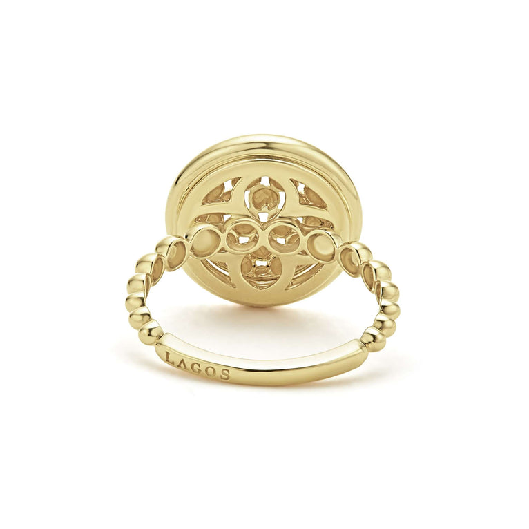 A back-view of An 18K Gold ring in the middle of a white background featuring caviar beading and smooth gold detailing.