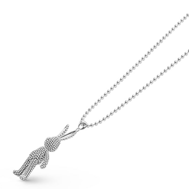 A close-up of a sterling silver angled to the right, featuring a rabbit pendant with Caviar beading finished on a ball chain necklace