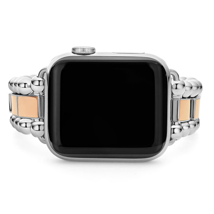 An Apple watch rests in the middle horizontally with a white background, showcasing the Apple watch face. The watch band features 18K rose-gold stationed links and stainless steel beading around the links.