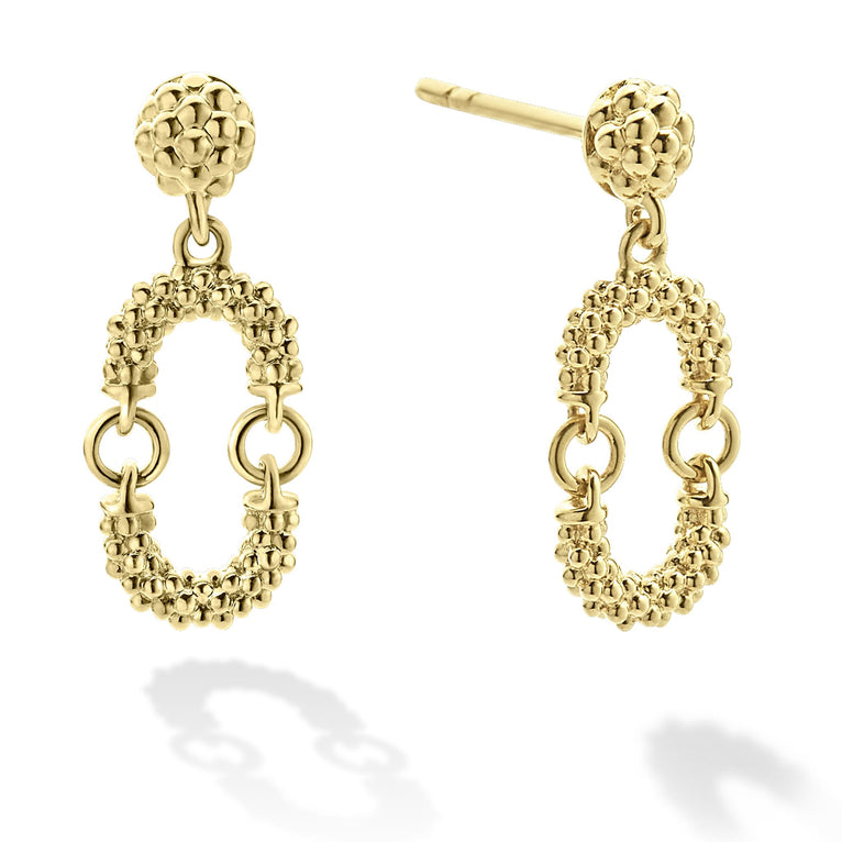 A pair of drop earrings with a link motif of 18K gold with superfine Caviar beads. The right earring is angled to the side.