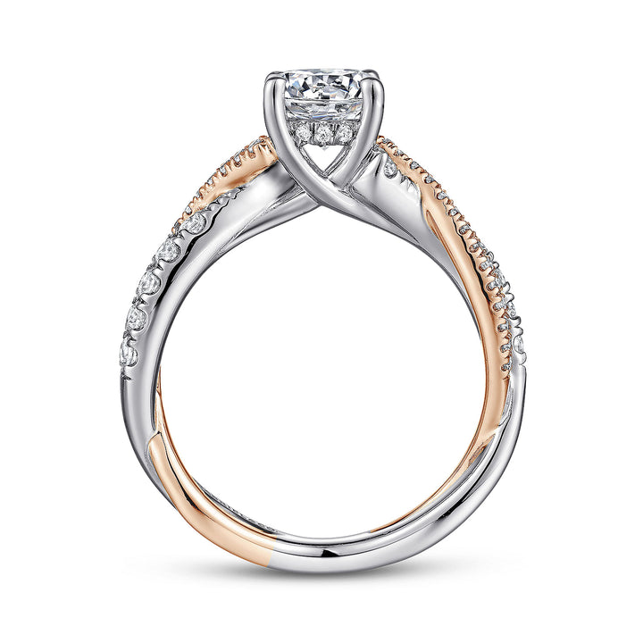 A side view of a ring made of white and rose gold. The side view shows the diamond's pavilion and the white and rose-gold band.