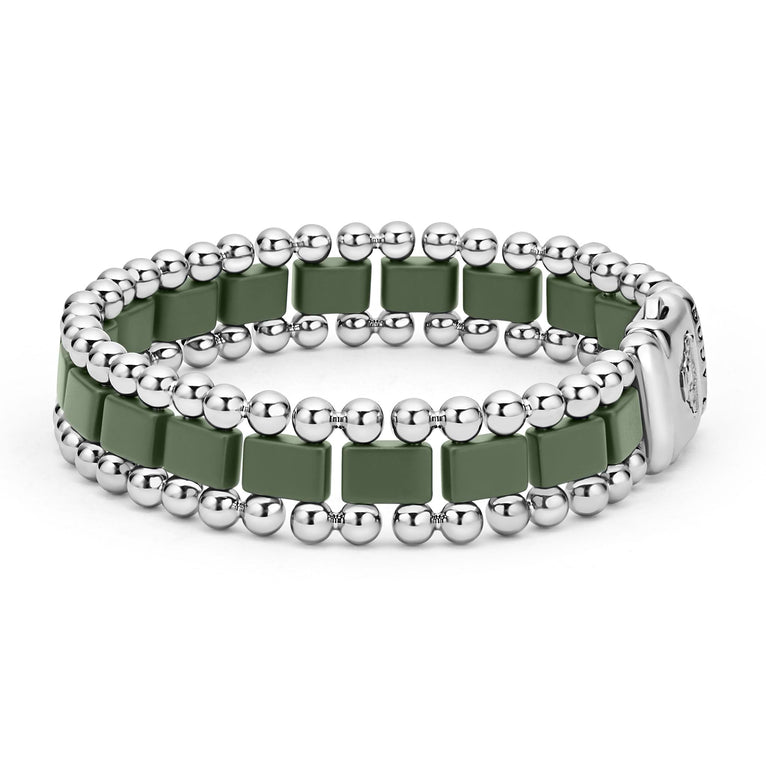 A side-view of a stainless steel bracelet in the middle of a white background featuring matte hunter-green ceramic and caviar beading.