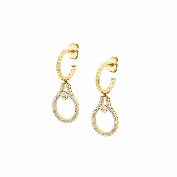 Two yellow-gold earrings lying flat across a white background. The earrings feature bezel-set diamonds on a namesake pendant.