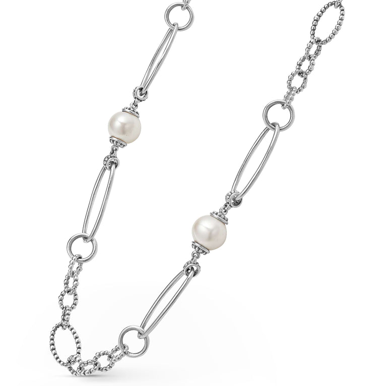 A sterling silver necklace angled to the right featuring five cultured freshwater pearl stations and Caviar beading displayed on a white background.