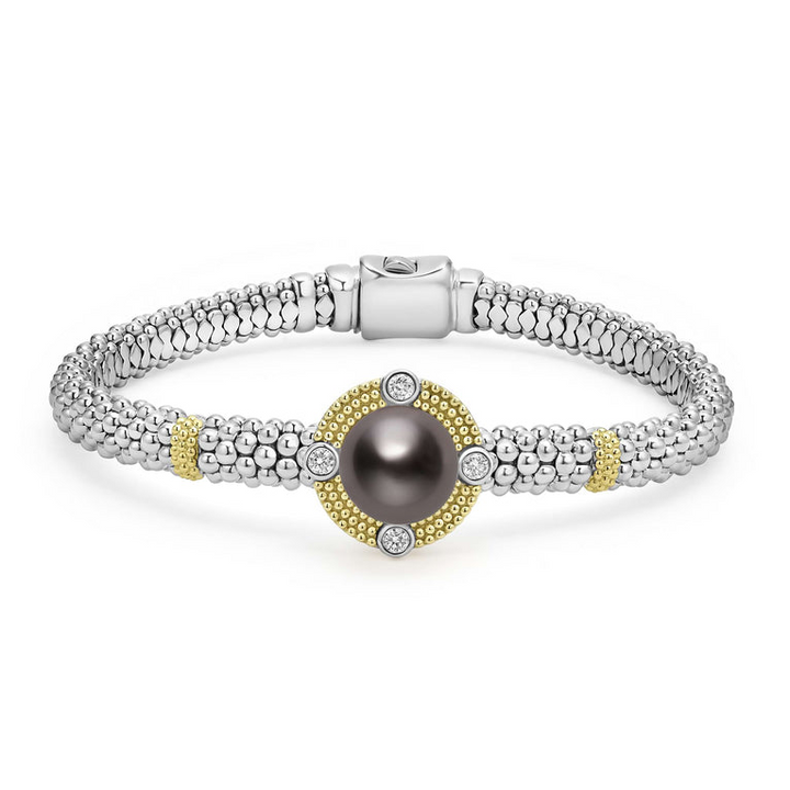 A Sterling silver & 18k gold bracelet in the middle of a white background featuring a Tahitian black pearl surrounded by diamonds, gold stations, and caviar beading.