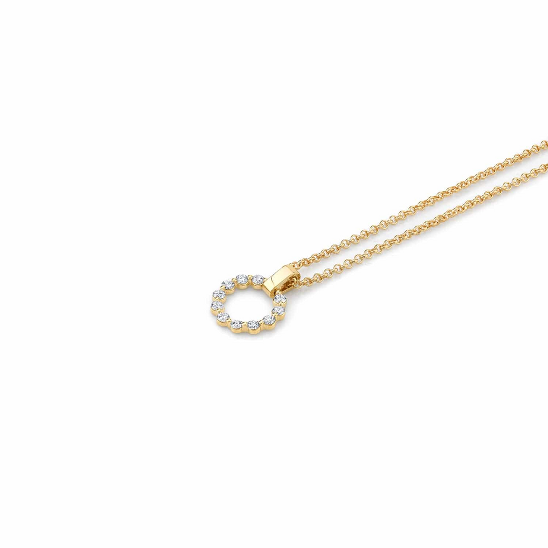 A yellow-gold necklace lying flat across a white background. The bracelet features a circle pendant and a smooth gold bar with a belcher chain.