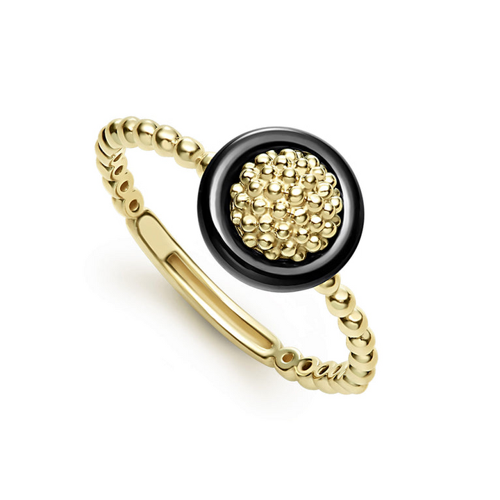 An 18K Gold ring in the middle of a white background featuring caviar beading framed by black ceramic